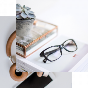 Stylized home office flat lay with headphones, eyeglasses, a succulent, and a tablet