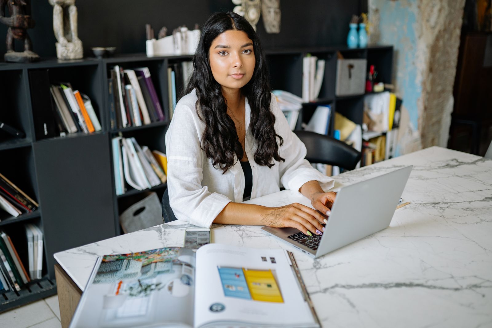 An Indian marketing professional working on a laptop in a modern office, representing top digital marketing companies in Bangalore